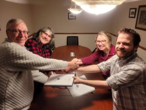 Shaking hands after signing all legal documents.