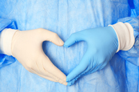gloved hands in shape of heart
